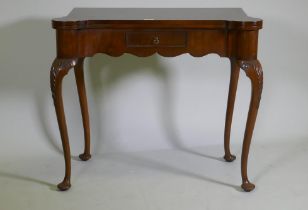 A George style walnut card table with shaped top and frieze, fitted with a single drawer, raised