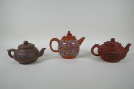 Three Chinese YiXing teapots, one with famille rose enamelled floral decoration, AF, largest 13cm