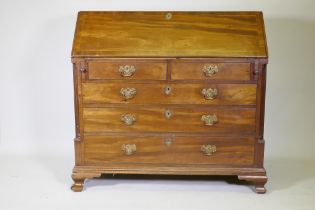 A George III mahogany fall front bureau with inlaid fitted interior over two and three drawers