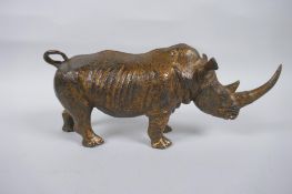 A gilt bronzed metal rhinoceros, 24cm long