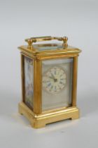 A miniature brass cased carriage clock with Sevres style porcelain panels, 6cm high