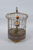 A brass birdcage automaton clock with a decorative cloisonne band, 18cm high