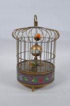 A brass birdcage automaton clock with a decorative cloisonne band, 18cm high