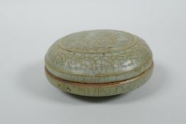 A Chinese celadon crackle glazed porcelain box and cover with raised mythical creature decoration,
