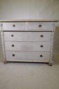 A C19th continental pine commode of two over three drawers flanked by column mouldings, raised on