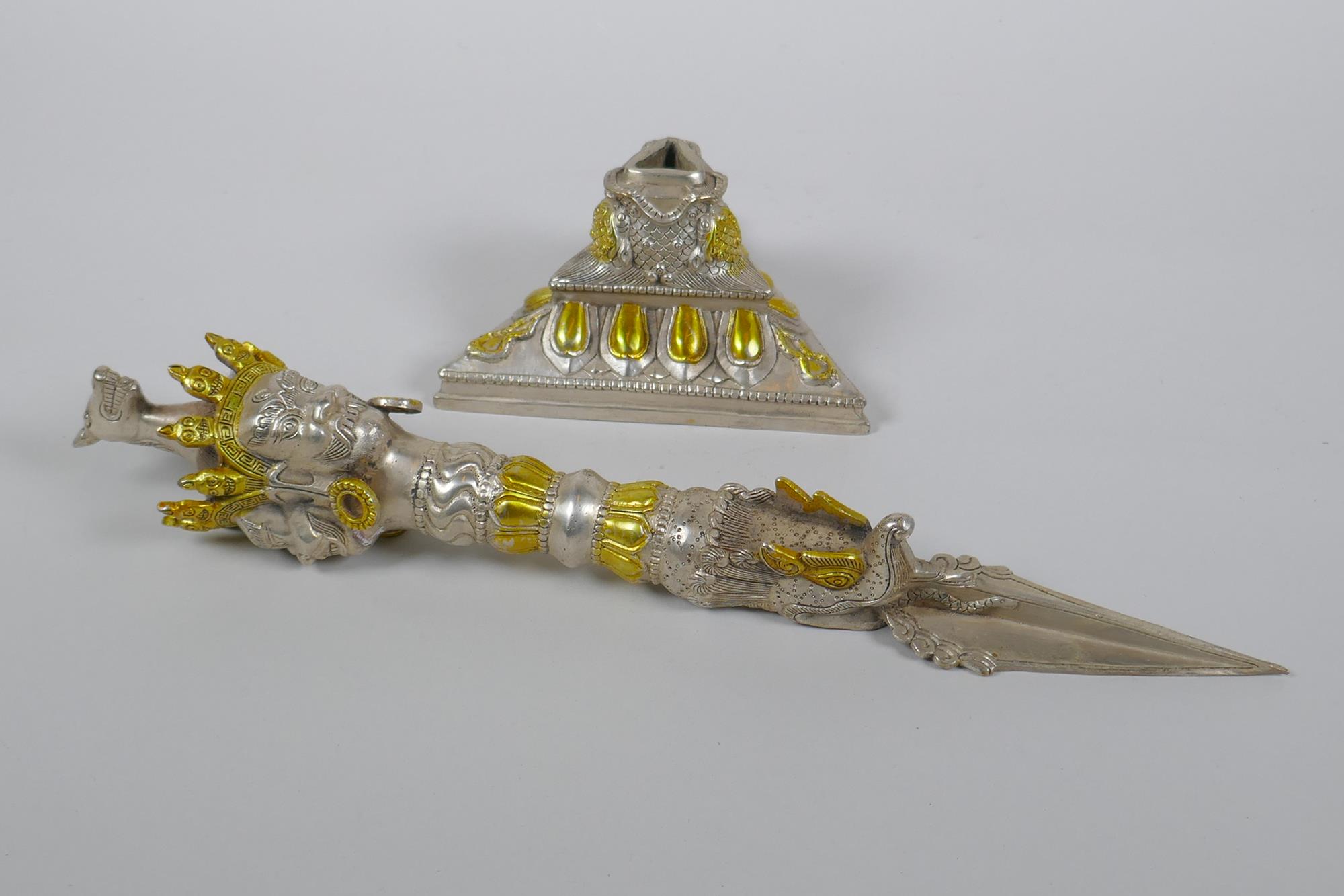 A Tibetan ceremonial metal phurba and stand with gilt metal highlights and wrathful deity masks to - Image 4 of 5