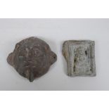 An antique Indian lead filled bronze lion head door mount, and a cast metal Buddha pendant, 6.5cm