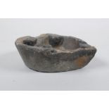 An antique carved stone oil lamp, 13 x 10cm