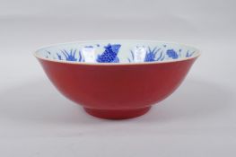 A Chinese porcelain bowl with blue and white decoration to the interior of carp and lotus flowers,