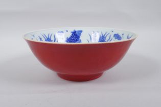A Chinese porcelain bowl with blue and white decoration to the interior of carp and lotus flowers,