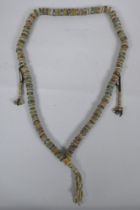 A Tibetan string of stone set bone mala beads, including turquoise, bone, nut, stone etc