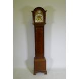 A mahogany cased grandmother clock with brass dial,  silvered metal bezel and Roman numerals, the