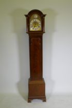 A mahogany cased grandmother clock with brass dial,  silvered metal bezel and Roman numerals, the