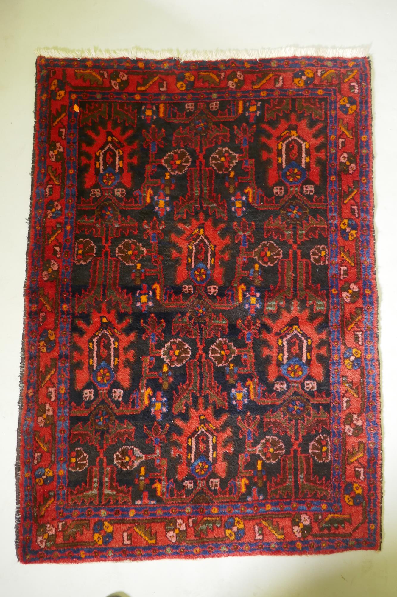 A Persian Hamadan red ground wool rug with unique geometric design, 148 x 104cm
