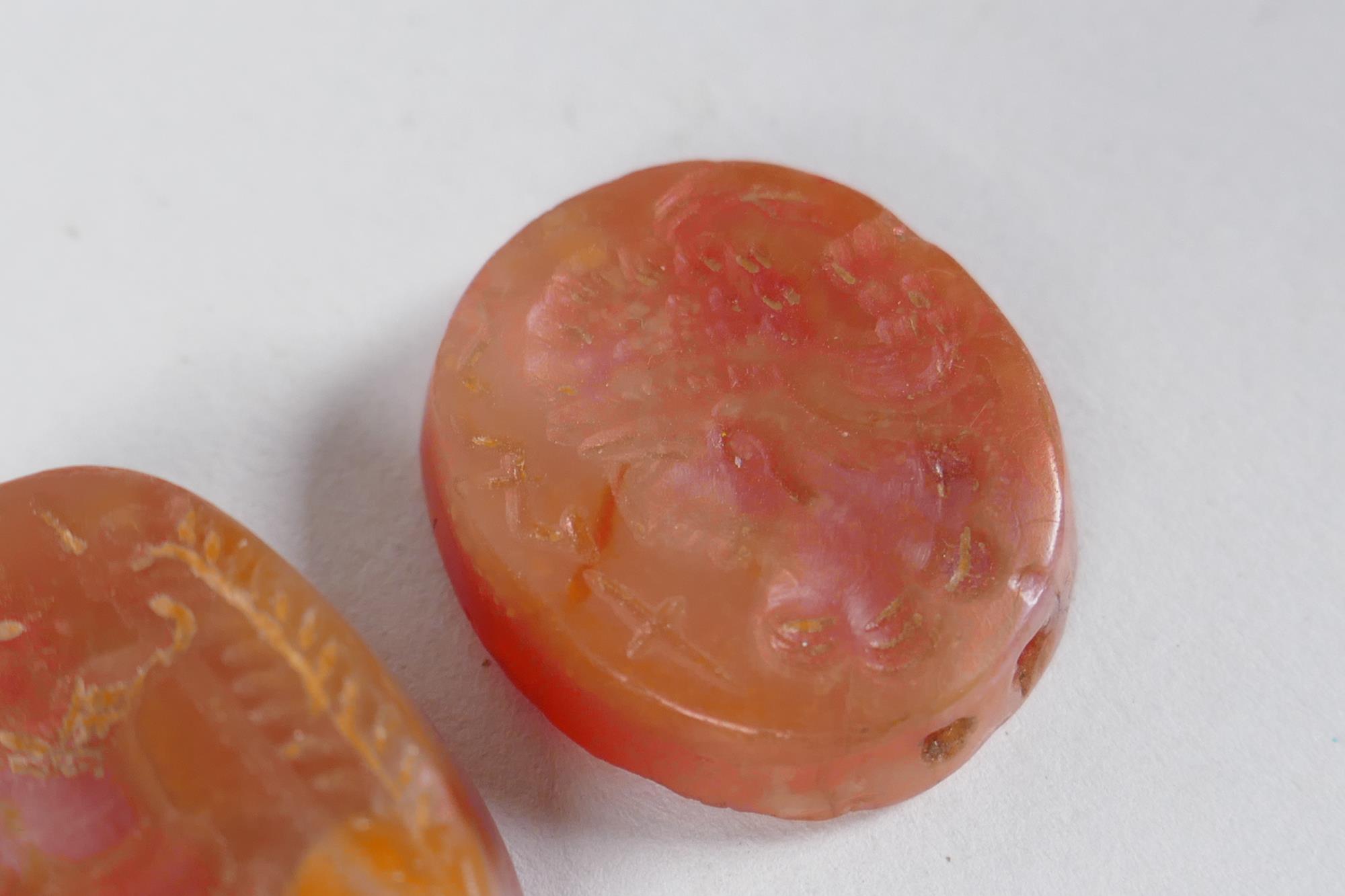 Two Persian amber agate intaglio beads with figural decoration, 2 x 2.5cm - Image 3 of 3