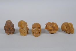 Five Japanese carved tagua nut netsuke in the form of rabbits, rats, monkeys and a skull, largest
