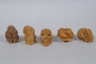 Five Japanese carved tagua nut netsuke in the form of rabbits, rats, monkeys and a skull, largest