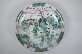 A famille verte porcelain charger decorated with women in a garden, Chinese KangXi 6 character