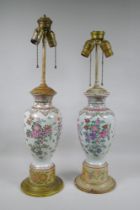 A pair of famille rose porcelain vases converted to lamps, with matching painted bases, 67cm highest