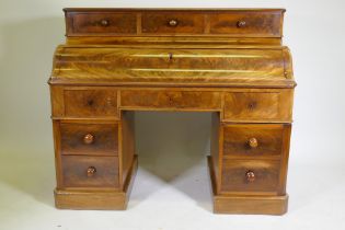A C19th continental mahogany pedestal desk, the upper section with three drawers over a pull down