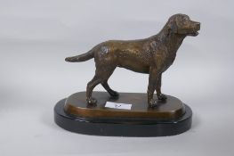 A bronze figure of a dog, mounted on a marble base, unsigned, 17cm high