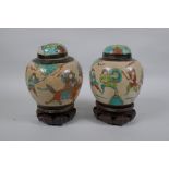 A pair of antique Chinese crackleware ginger jars and covers with polychrome enamel decoration of