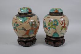 A pair of antique Chinese crackleware ginger jars and covers with polychrome enamel decoration of