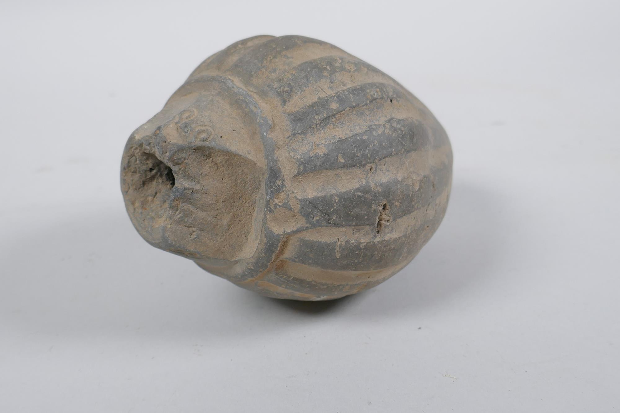 An early ceramic hand grenade/bomb, possibly C12th/C13th, with ribbed body and impressed motifs, - Image 2 of 5