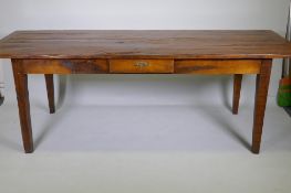 A French style oak farmhouse table with single drawer and cleated plank top, raised on square
