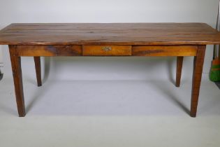 A French style oak farmhouse table with single drawer and cleated plank top, raised on square