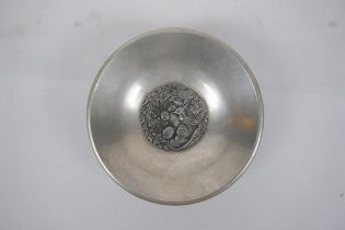 A Chinese white metal dish with raised phoenix and dragon decoration, character mark to base, 14cm