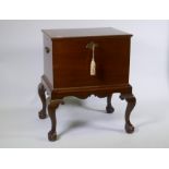 A George III mahogany wine cooler with lift up top and zinc lined interior, raised on a base with