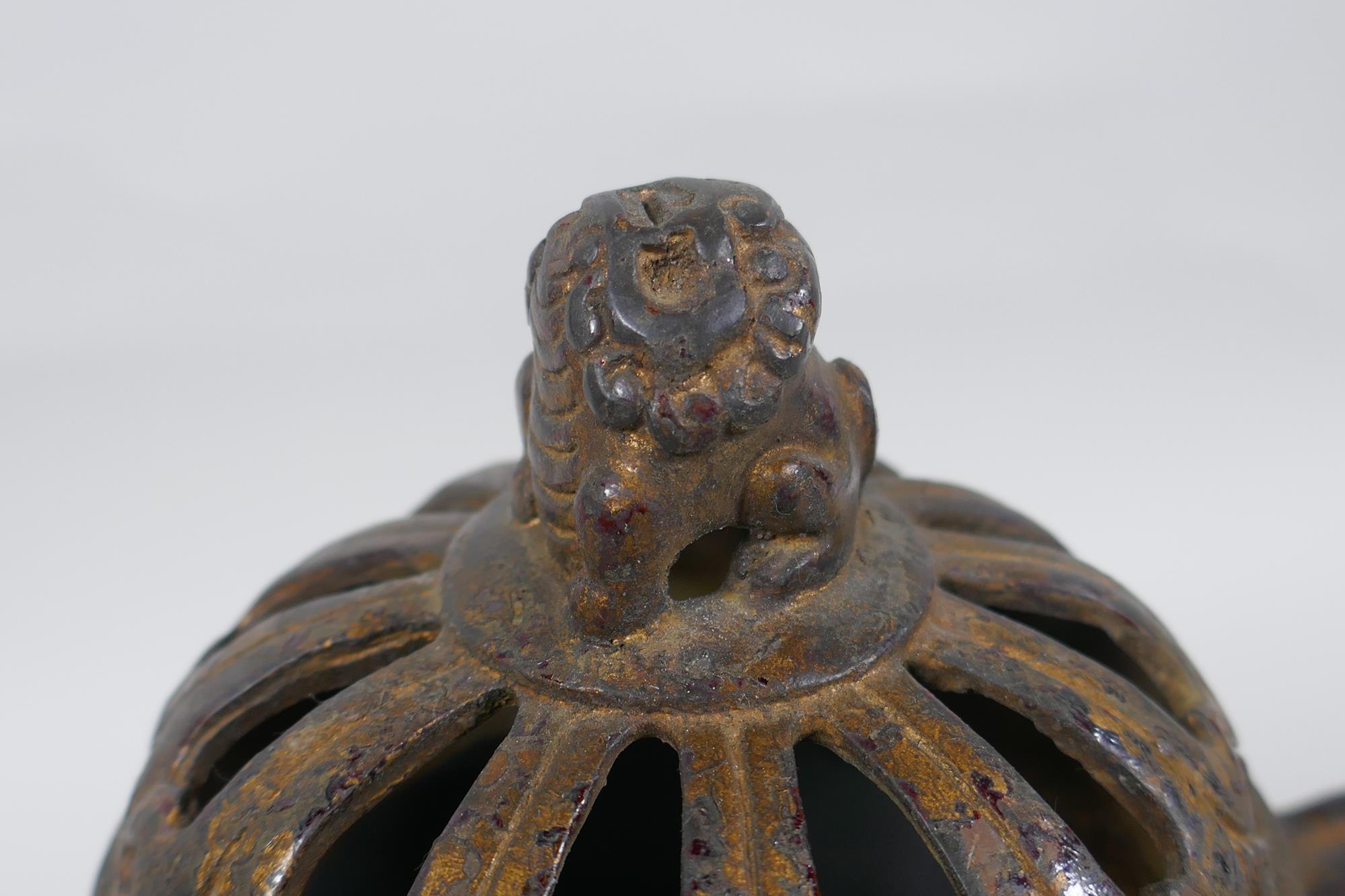 A Chinese gilt bronze censer and pierced cover, raised on tripod supports, with two dragon mask - Image 3 of 5