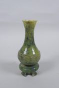 A Chinese mottled green jade stem vase, 13cm high
