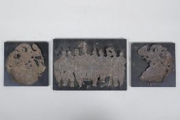 Three Mongolian white metal foil raised figural plaques, on ebonised wood panels, largest 20 x 14cm