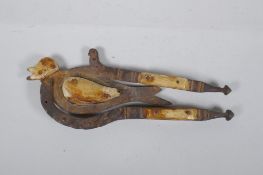 An antique Indian Betel nut cutter in the form of a bird, with bone mounts, 24cm long