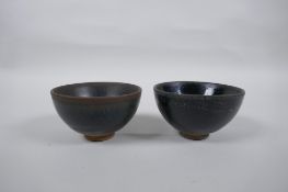 A Chinese Jian Kiln tea bowl with hares fur glaze, and another with a treacle glaze, 9cm diameter