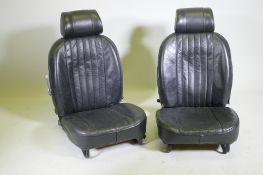 A pair of reclining car seats with head rests, 75cm high