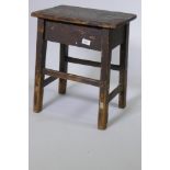 An antique oriental rustic stool, 42 x 30cm, 50cm high