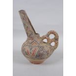 An Islamic terracotta wine jug with painted decoration, 22cm high