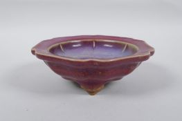 A Chinese Jun ware dish/censer on tripod supports with a petal shaped rim, character mark to base,