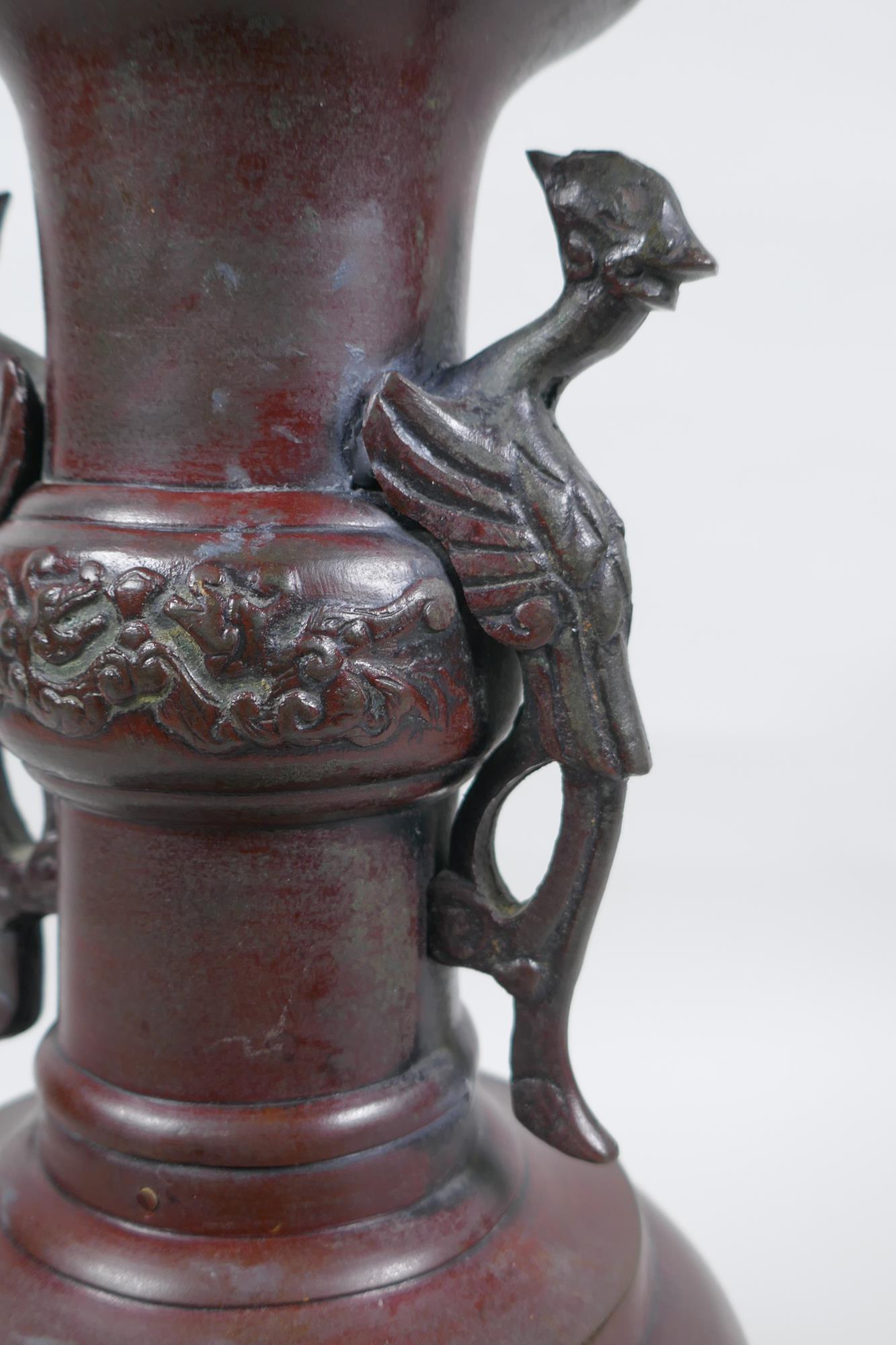 A Chinese bronze vase with two phoenix handles and raised panels depicting dragons, 30cm high - Image 2 of 6