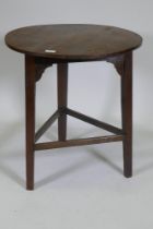 Antique oak cricket table, with planked top, plain frieze with shaped brackets and raised on scratch