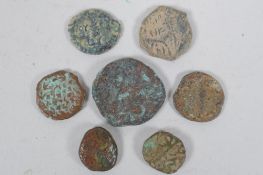 Seven archaic eastern metal coins, largest 2cm