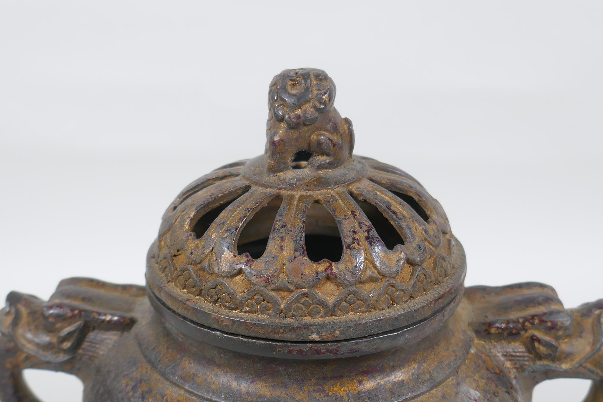 A Chinese gilt bronze censer and pierced cover, raised on tripod supports, with two dragon mask - Image 2 of 5