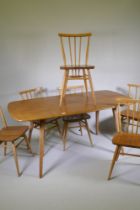 A set of six Ercol model 391 stick back chairs with elm seats, and a dining table, 150cm long