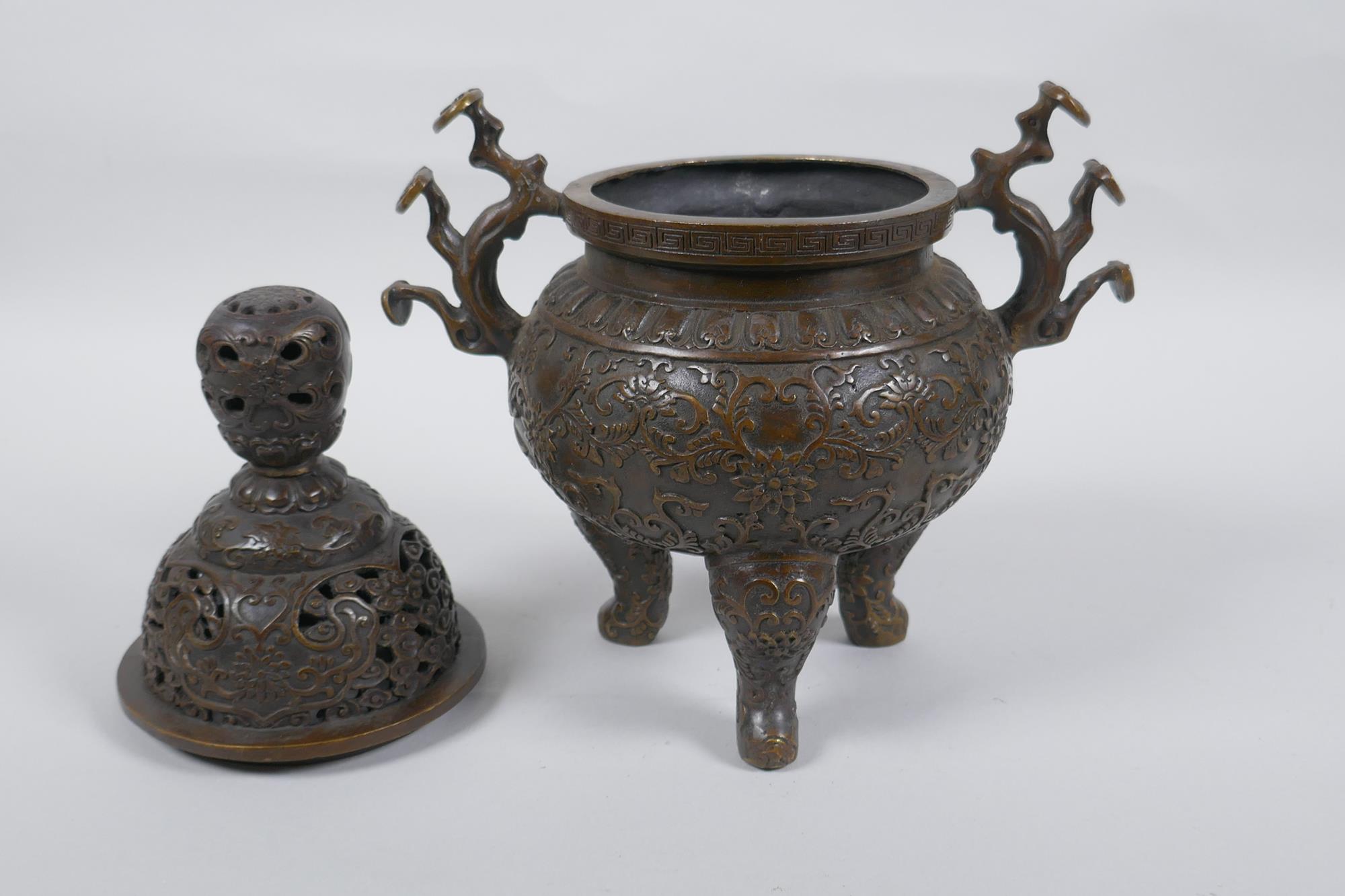 A Chinese bronze censer and cover on tripod supports, with two ruyi shaped handles and allover lotus - Image 2 of 5