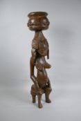 An African carved hardwood Senujo maternity figure, 63cm high
