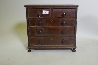 A C19th miniature mahogany chest of two over three drawers, raised on bun feet, 35 x 17 x 33cm