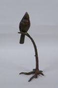 A bronze figure of a bird perched on a tree, 19cm high